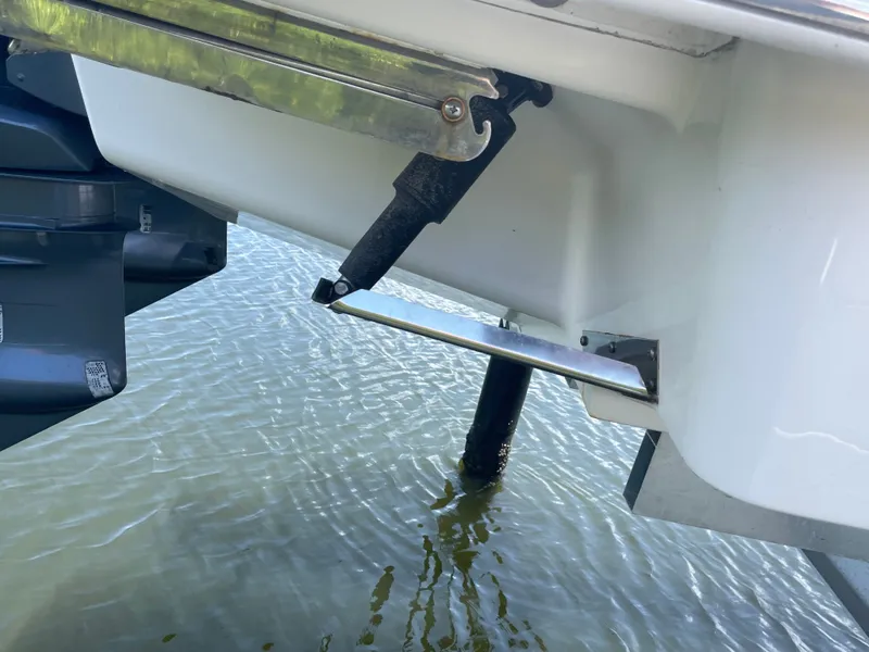 Slide: The Image of Part of the hull of a 2023 Chaparral 280OSX with a trim system in the water. - 13