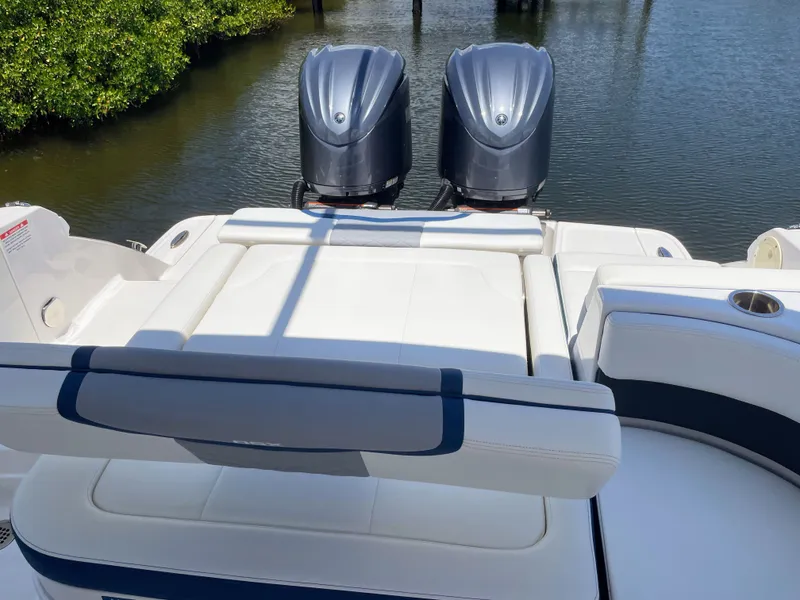 Slide: The Image of The image shows the stern of a 2023 Chaparral 280OSX boat with two outboard engines. - 35