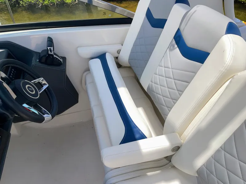 Slide: The Image of The 2023 Chaparral 280OSX seats are white with blue accents and feature a quilted pattern. - 42