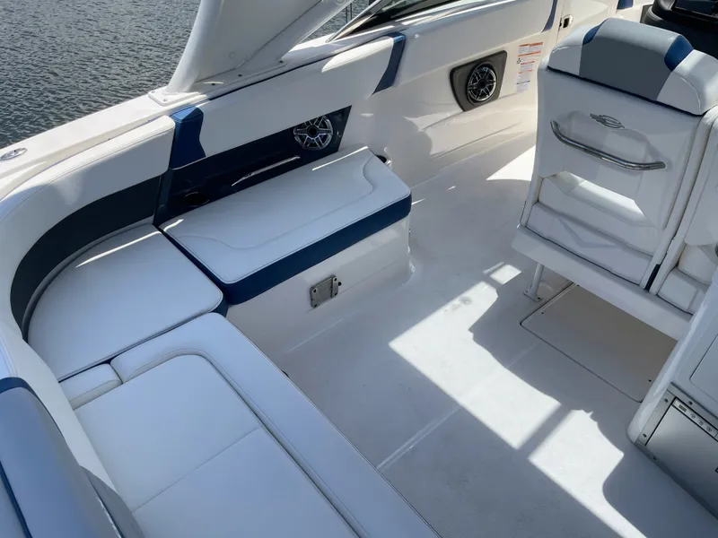 Slide: The Image of The image shows the cockpit of a 2023 Chaparral 280OSX with white and blue upholstery. - 29