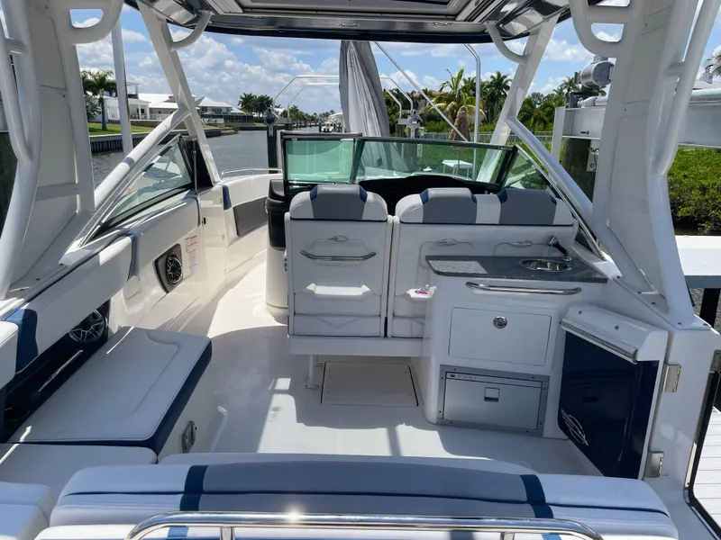 Slide: The Image of The image shows the cockpit of a 2023 Chaparral 280OSX boat with sleek seating and a small sink. - 26