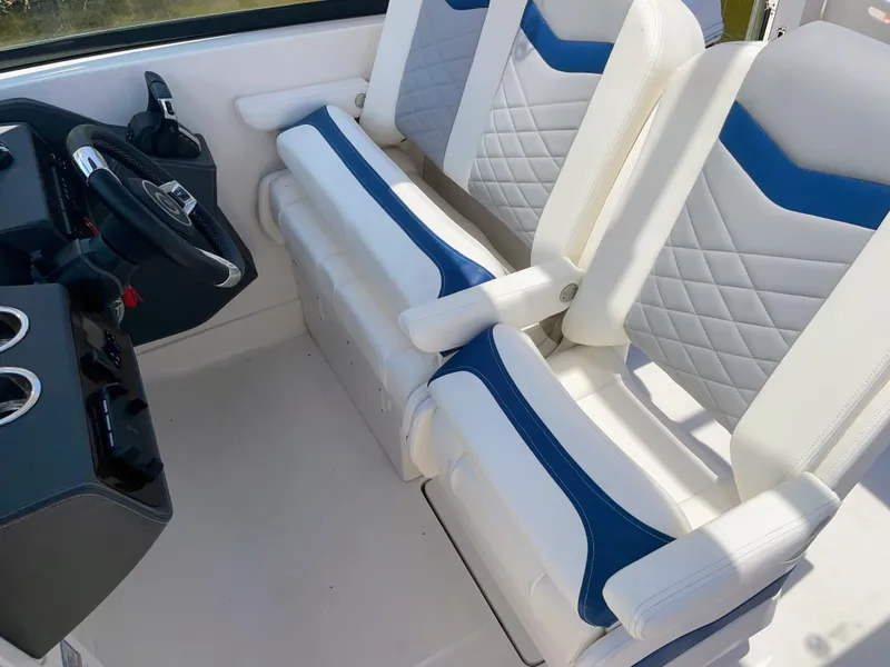 Slide: The Image of Two luxurious, padded seats with blue and white accents in a modern boat. - 43