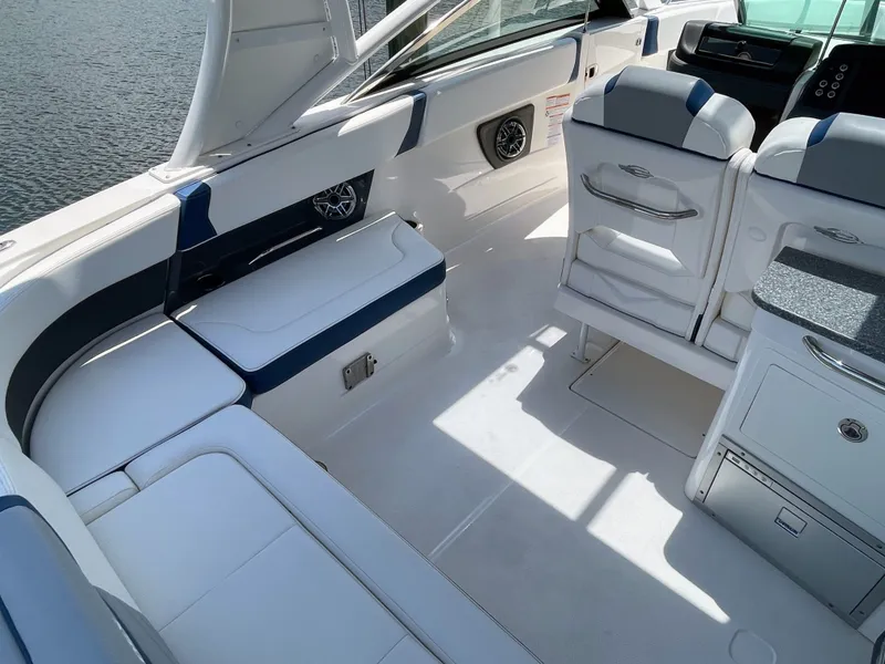 Slide: The Image of The image shows the cockpit of a 2023 Chaparral 280OSX with white and blue seating. - 30