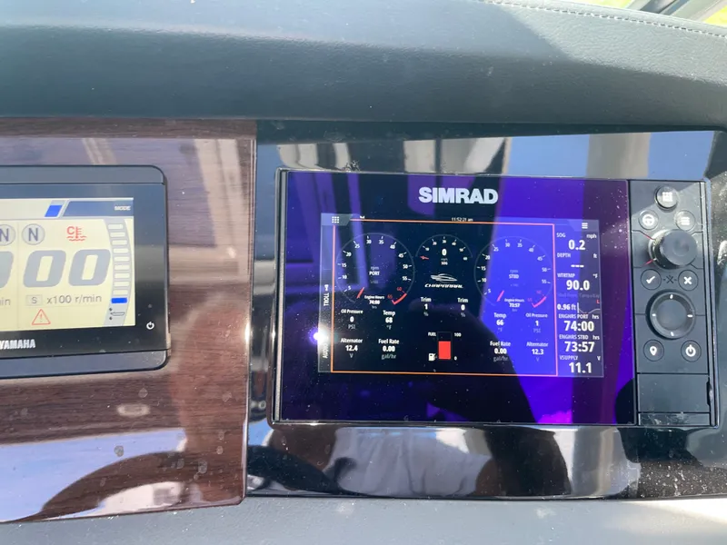 Slide: The Image of The image shows a modern dashboard with Simrad and Yamaha displays on a Chaparral 280OSX boat. - 47