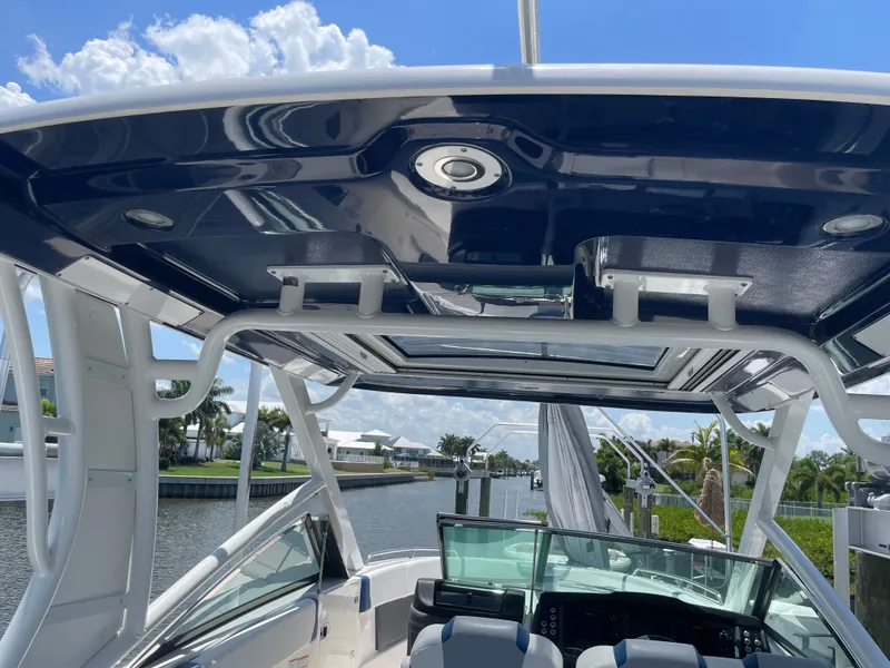 Slide: The Image of The image shows the cockpit of a 2023 Chaparral 280OSX with a sleek hardtop and clear view. - 36