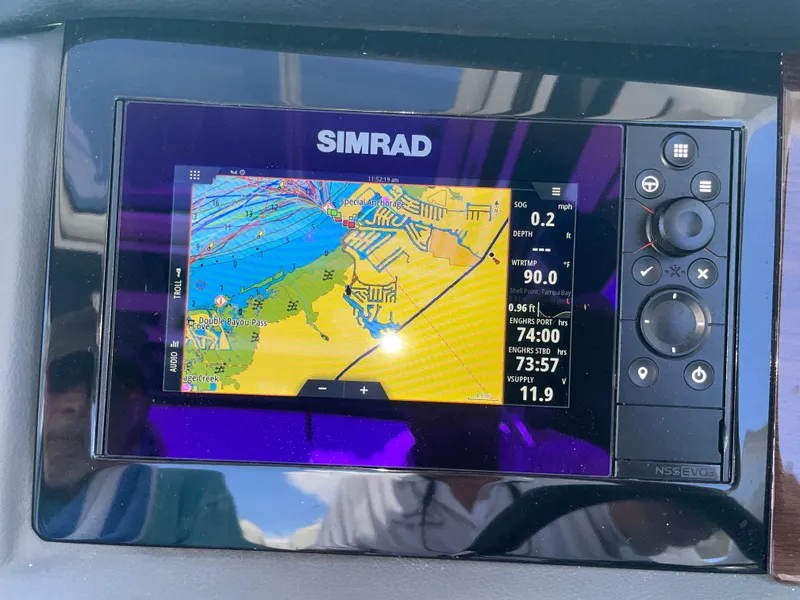 Slide: The Image of A Simrad navigation system on a 2023 Chaparral 280OSX boat displays a detailed nautical chart. - 46