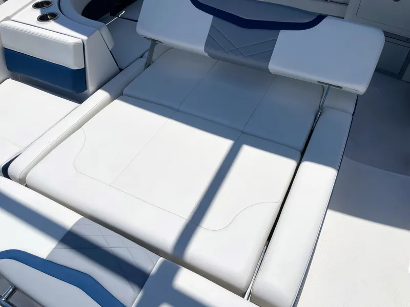 Slide: The Image of The 2023 Chaparral 280OSX features luxurious white upholstery with blue accents in the seating area. - 34