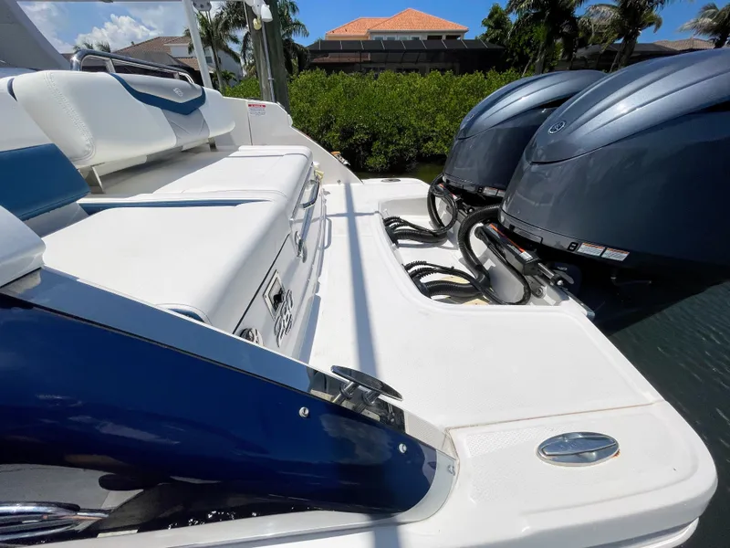 Slide: The Image of The image shows the stern of a 2023 Chaparral 280OSX boat with two outboard engines. - 20