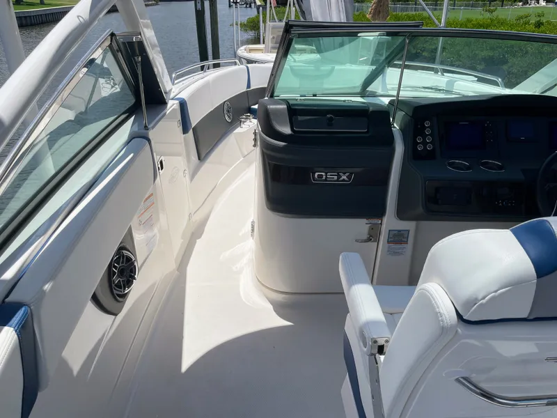 Slide: The Image of The image shows the cockpit of a 2023 Chaparral 280OSX boat with modern instruments. - 37