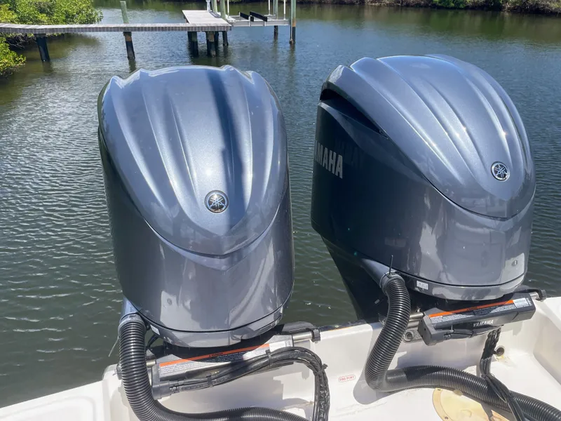Slide: The Image of Two Yamaha outboard engines on a Chaparral 280OSX boat, situated on calm water. - 16