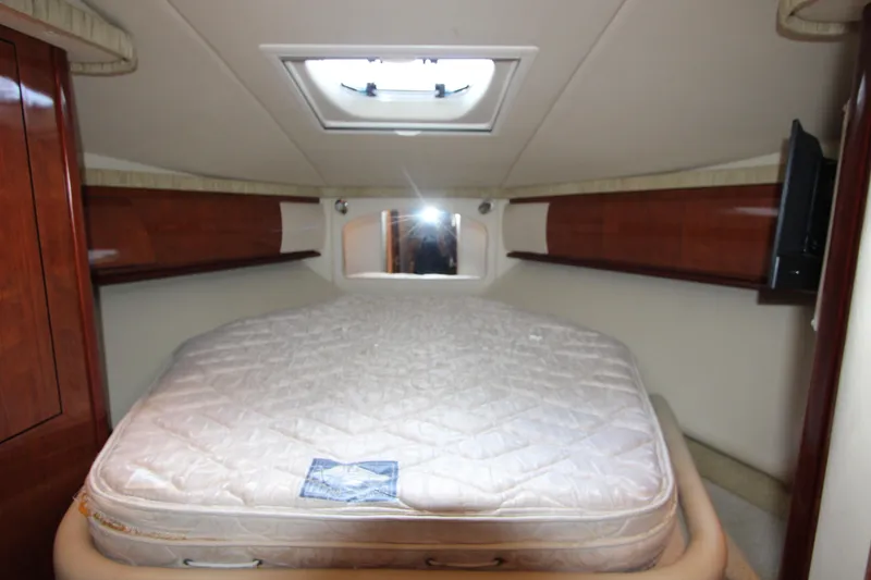 Slide: The Image of Interior cabin of 2005 Sea Ray 420 Sundancer with bed and wooden cabinetry. - 19