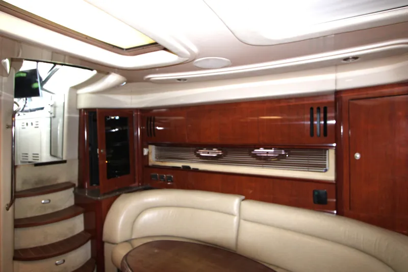 Slide: The Image of Interior of 2005 Sea Ray 420 Sundancer yacht with elegant wood finish and plush seating. - 17
