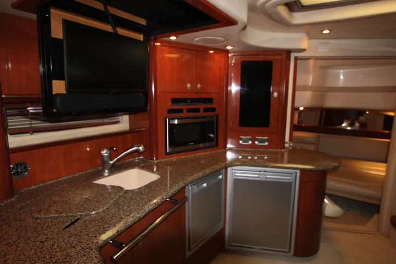Slide: The Image of Luxurious interior of 2005 Sea Ray 420 Sundancer yacht with modern kitchen amenities. - 15