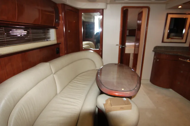 Slide: The Image of Luxurious interior of 2005 Sea Ray 420 Sundancer yacht with elegant seating and wooden finishes. - 14