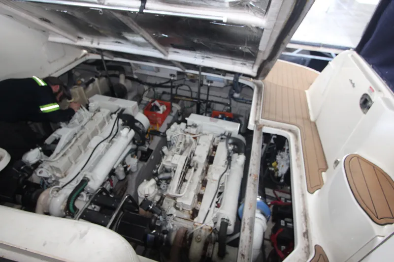 Slide: The Image of Engine compartment of a 2005 Sea Ray 420 Sundancer with visible twin engines. - 26