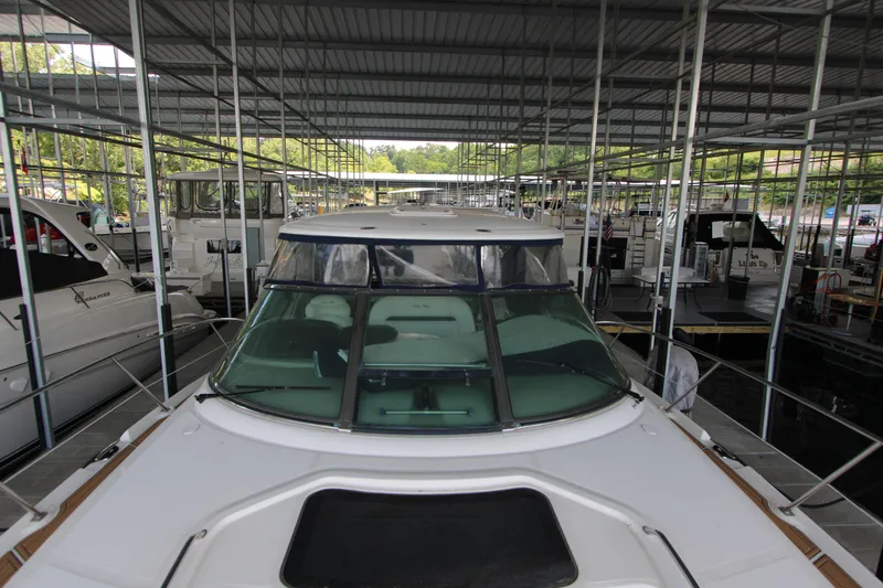 Slide: The Image of 2005 Sea Ray 420 Sundancer yacht docked in a covered marina. - 10