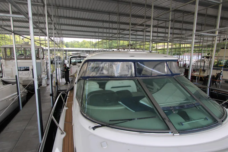 Slide: The Image of 2005 Sea Ray 420 Sundancer yacht docked in a covered marina. - 11