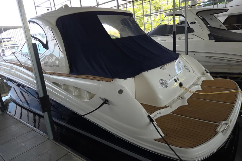 Slide: The Image of 2005 Sea Ray 420 Sundancer yacht docked in a marina, rear view. - 4