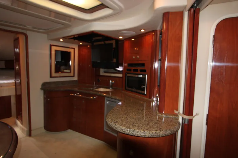 Slide: The Image of Luxurious 2005 Sea Ray 420 Sundancer yacht interior with elegant wood cabinetry and granite countertops. - 13