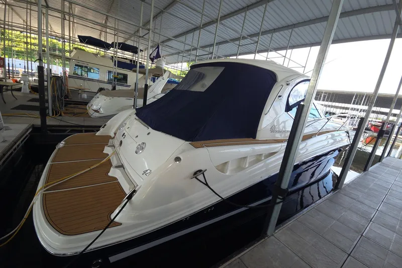 Slide: The Image of 2005 Sea Ray 420 Sundancer yacht docked in a covered marina. - 1