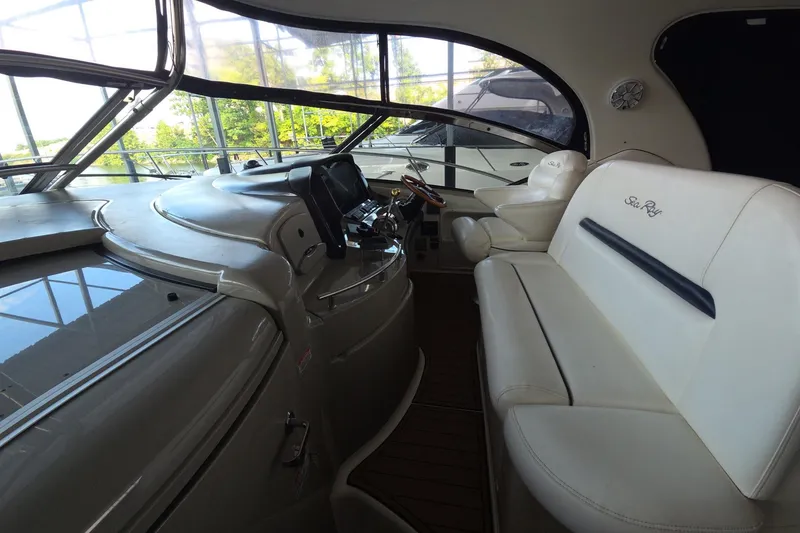 Slide: The Image of Interior of 2005 Sea Ray 420 Sundancer yacht with plush seating and modern controls. - 2