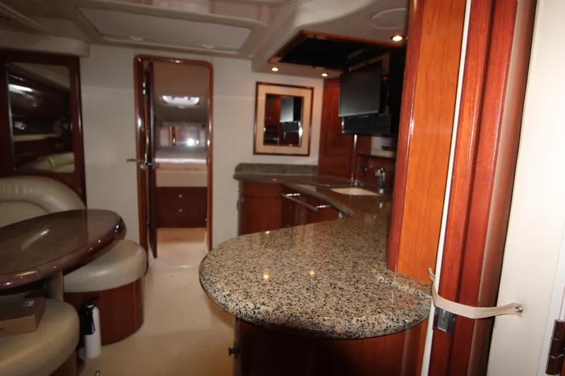 Slide: The Image of Interior of 2005 Sea Ray 420 Sundancer yacht with granite countertops and wood finishes. - 21