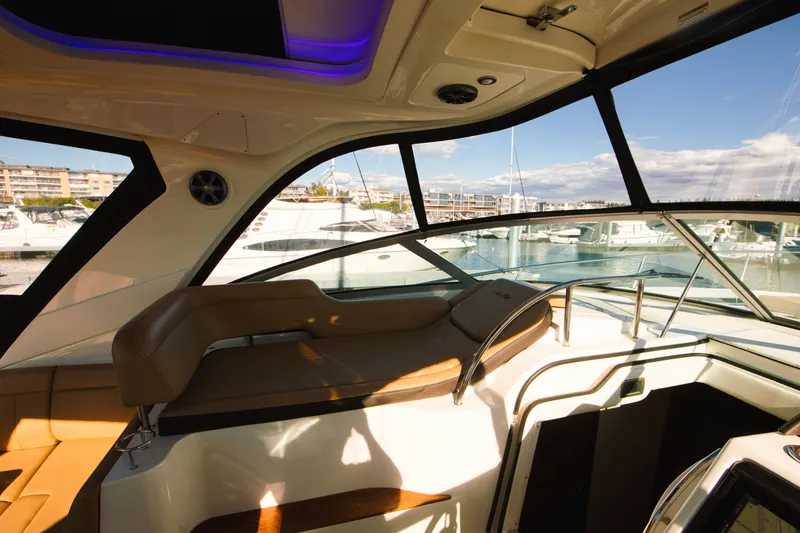 Slide: The Image of Interior of a 2021 Sea Ray Sundancer 350 with elegant seating and large windows. - 12