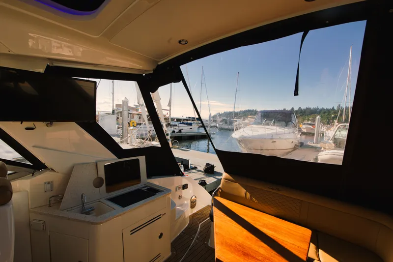 Slide: The Image of Interior view of a 2021 Sea Ray Sundancer 350 overlooking a marina. - 18