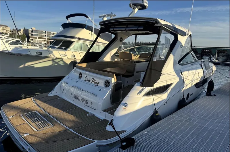 Slide: The Image of A 2021 Sea Ray Sundancer 350 docked. It features a sleek design and spacious deck area. - 7