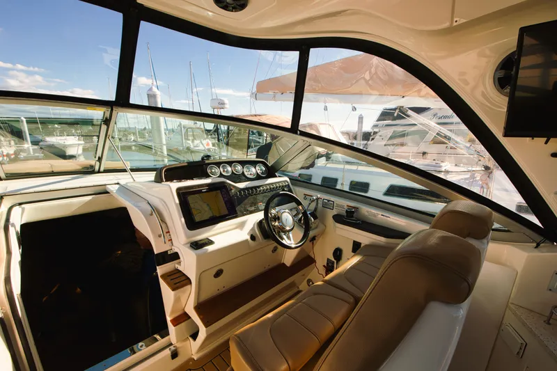 Slide: The Image of The cockpit of a 2021 Sea Ray Sundancer 350 with a modern helm and comfortable seating. - 17