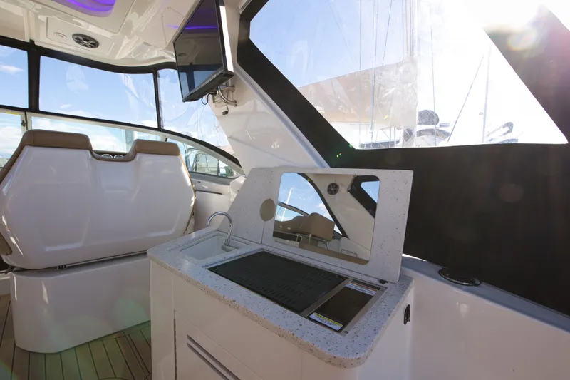Slide: The Image of Interior of a 2021 Sea Ray Sundancer 350 with modern amenities and large windows. - 16