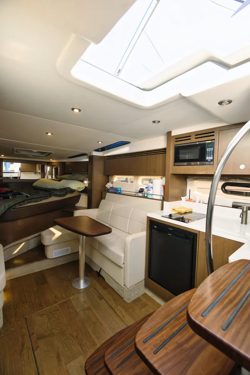 Slide: The Image of Interior of a 2021 Sea Ray Sundancer 350 with modern kitchen and cozy seating area. - 5