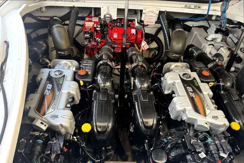Slide: The Image of The engine room of a 2021 Sea Ray Sundancer 350 shows powerful engines and wiring. - 13