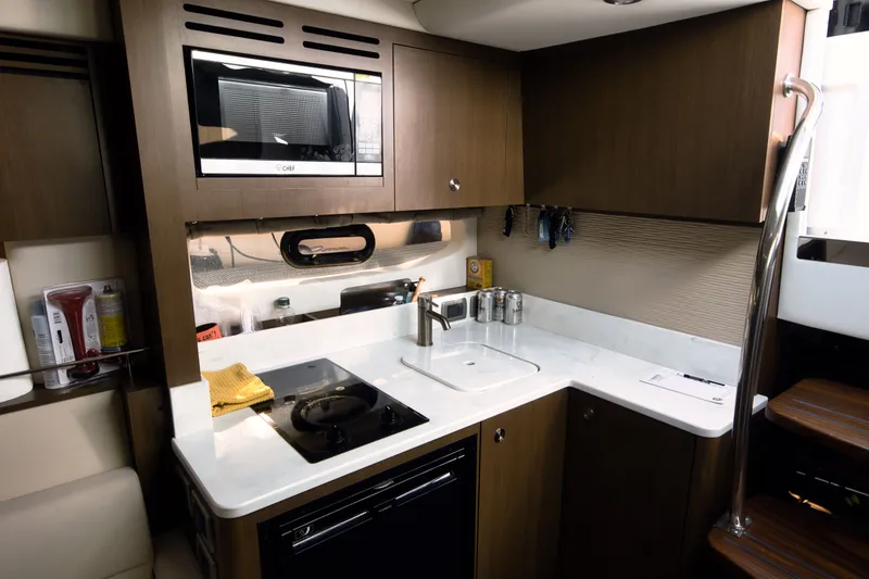 Slide: The Image of The galley of a 2021 Sea Ray Sundancer 350 with a microwave and stove. - 3