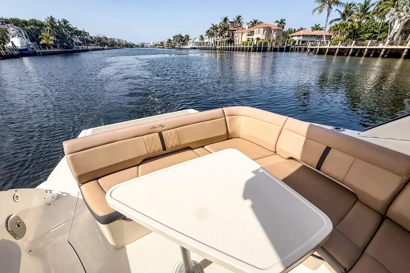 Slide: The Image of 2016 Sea Ray Sundancer 350 yacht with luxurious seating, cruising on a scenic waterway. - 10