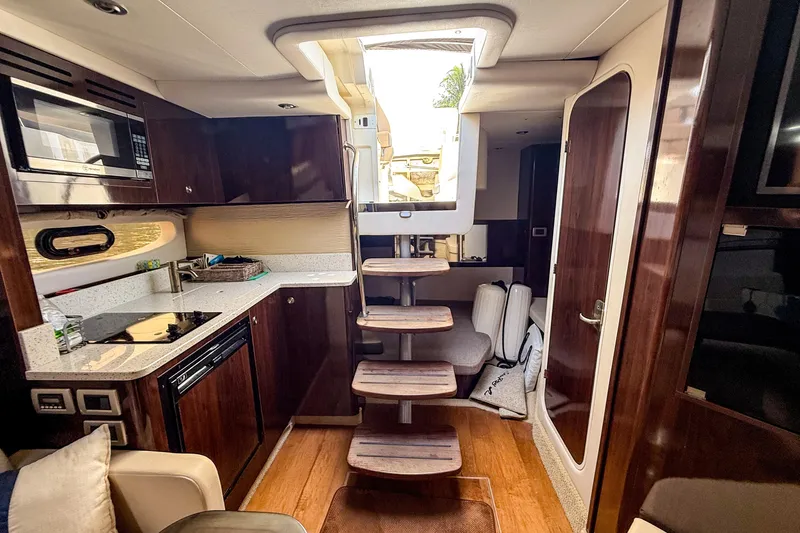 Slide: The Image of Interior of 2016 Sea Ray Sundancer 350 yacht with modern kitchen and wooden stairs. - 26