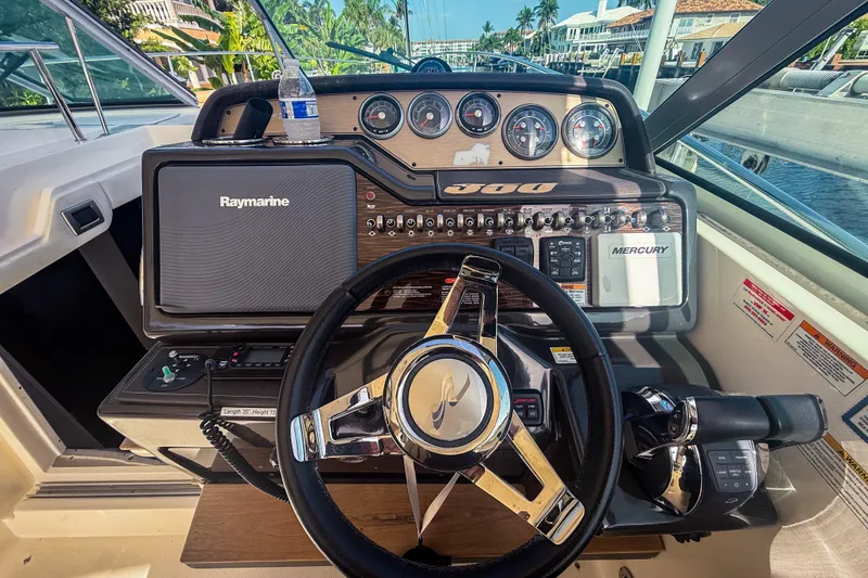 Slide: The Image of Helm of 2016 Sea Ray Sundancer 350 with Raymarine navigation system and Mercury controls. - 22