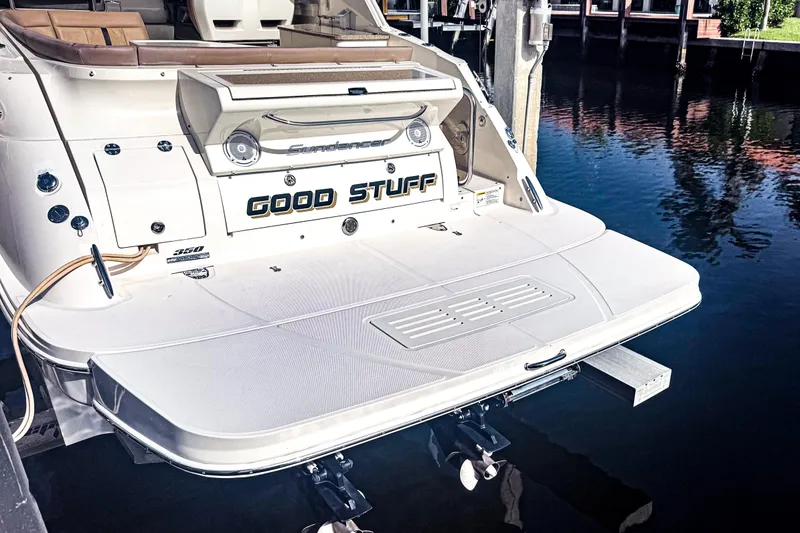 Slide: The Image of 2016 Sea Ray Sundancer 350 yacht docked, featuring a spacious swim platform. - 6