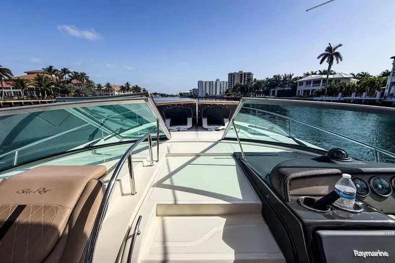 Slide: The Image of 2016 Sea Ray Sundancer 350 yacht cruising on a sunny canal with palm trees. - 34