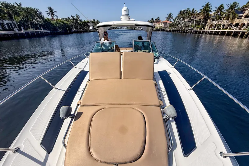 Slide: The Image of 2016 Sea Ray Sundancer 350 yacht cruising on a scenic waterway with palm trees. - 41