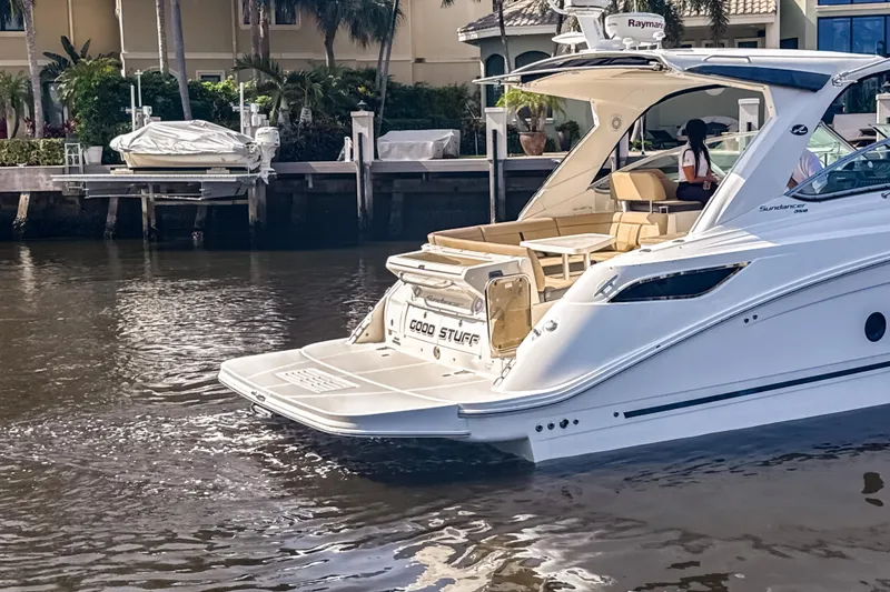 Slide: The Image of 2016 Sea Ray Sundancer 350 yacht docked in a serene waterfront setting. - 4