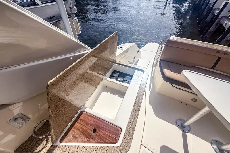 Slide: The Image of 2016 Sea Ray Sundancer 350 boat interior with seating and storage area. - 16