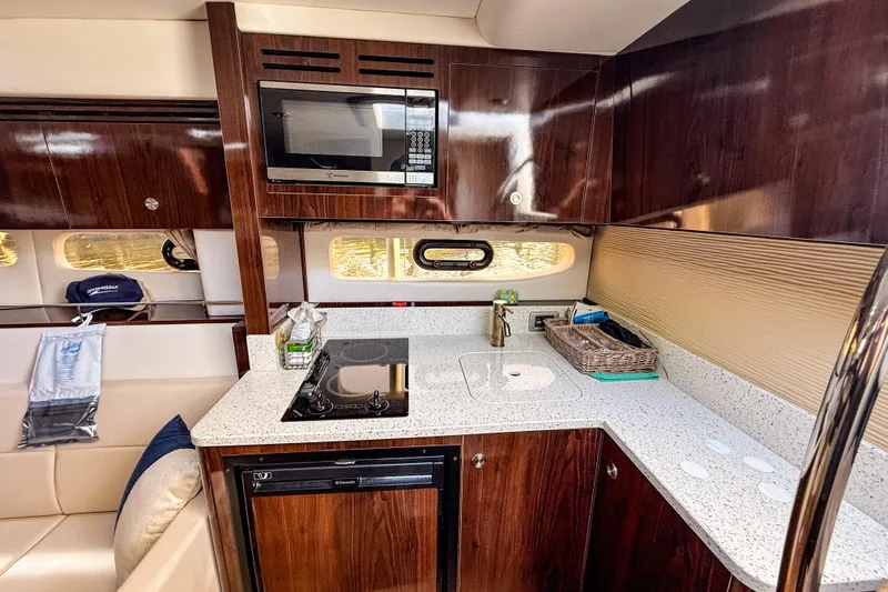Slide: The Image of Luxurious 2016 Sea Ray Sundancer 350 yacht kitchen with modern appliances and sleek wood cabinetry. - 32
