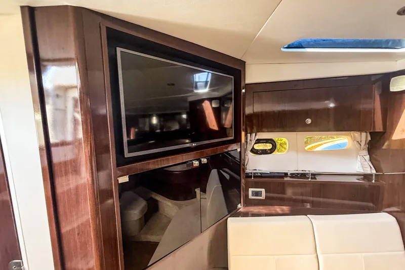 Slide: The Image of Interior of 2016 Sea Ray Sundancer 350 yacht with TV and wooden cabinetry. - 30