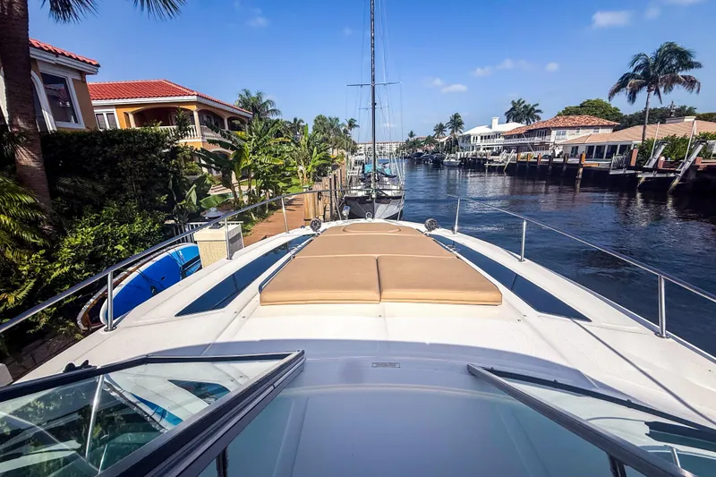 Slide: The Image of 2016 Sea Ray Sundancer 350 cruising through a scenic canal with palm trees and luxury homes. - 35