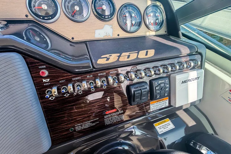 Slide: The Image of Control panel of a 2016 Sea Ray Sundancer 350 boat with gauges and switches. - 25