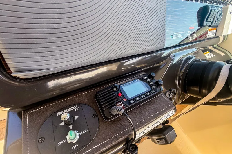 Slide: The Image of Control panel of a 2016 Sea Ray Sundancer 350 boat with radio and switches. - 24