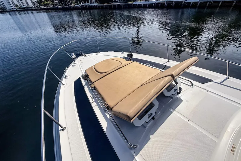 Slide: The Image of 2016 Sea Ray Sundancer 350 boat with sunpad on deck, docked by calm waters. - 37