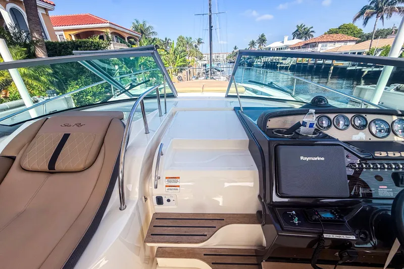 Slide: The Image of 2016 Sea Ray Sundancer 350 cockpit with navigation equipment and luxurious seating. - 21