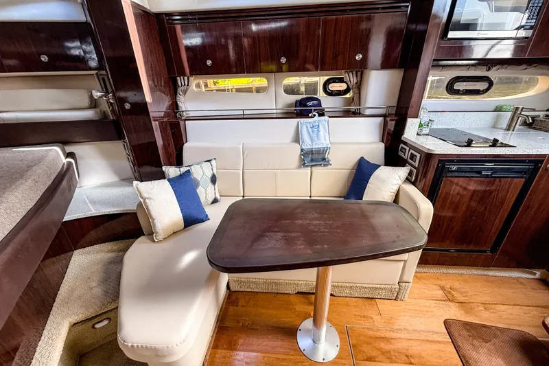 Slide: The Image of Luxurious interior of 2016 Sea Ray Sundancer 350 yacht with elegant seating and kitchenette. - 31